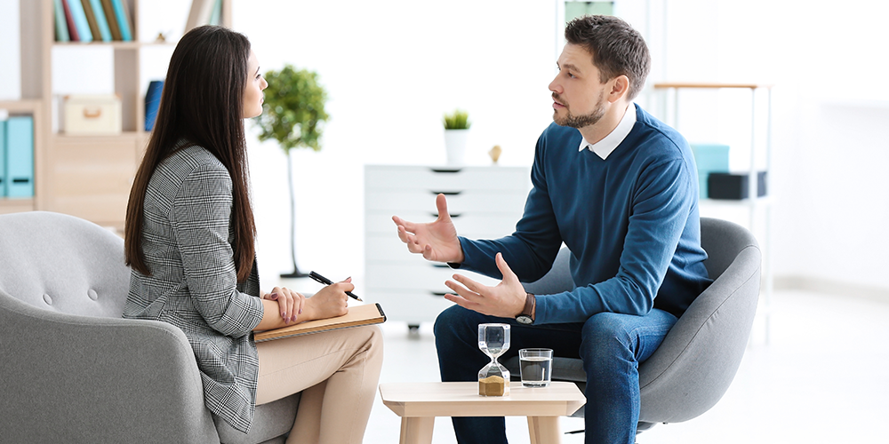 two people sitting having a serious conversation