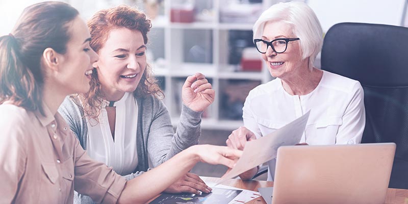 Women colleagues of multiple generations working together