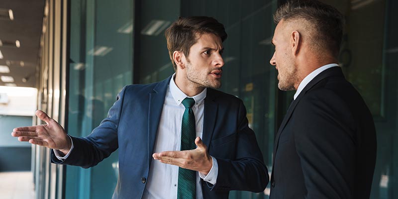 Two men are involved in a verbal conflict while at work.